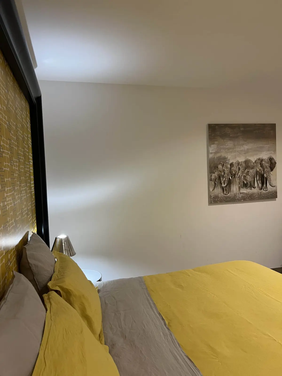 Tournesols room at Chut ! c'est ici with mustard-yellow and grey bed linen and an elephant painting
