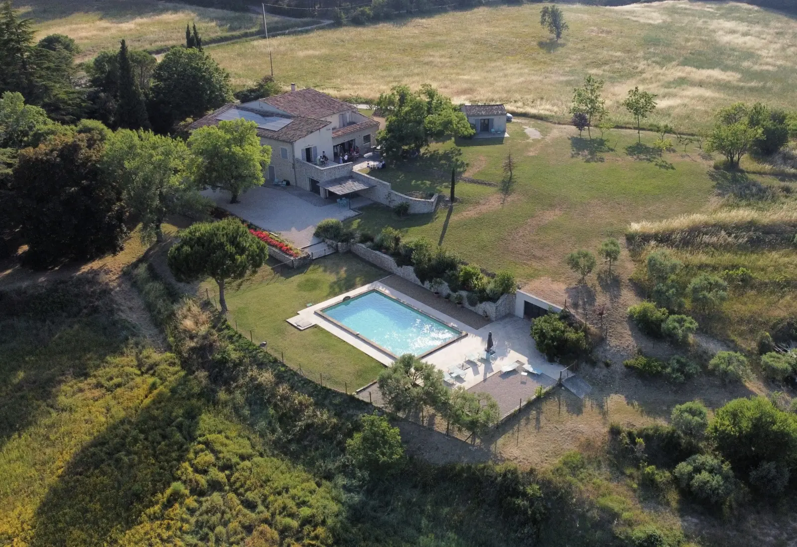 Aerial view of Chut ! c'est ici: house, pool and garden surrounded by meadows and woodland