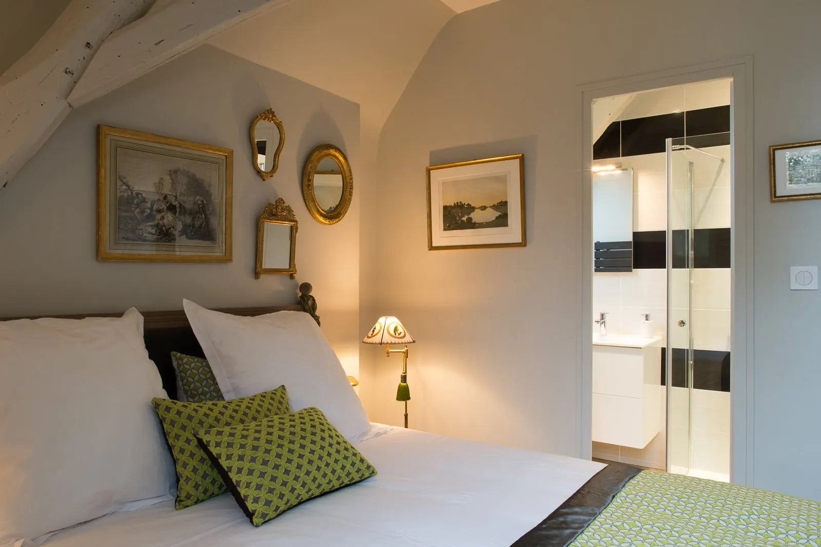 Bed with green cushions, prints, gilt mirrors and a shower room with a glass shower, La Folie Saint Julien
