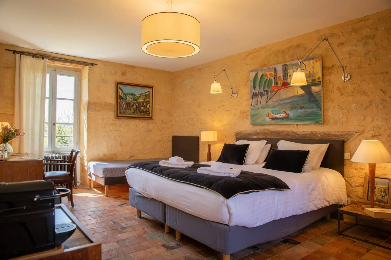Paris suite at Les Hauts de Saint-Vincent: large bed, extra bed, stone walls, terracotta tiles and paintings