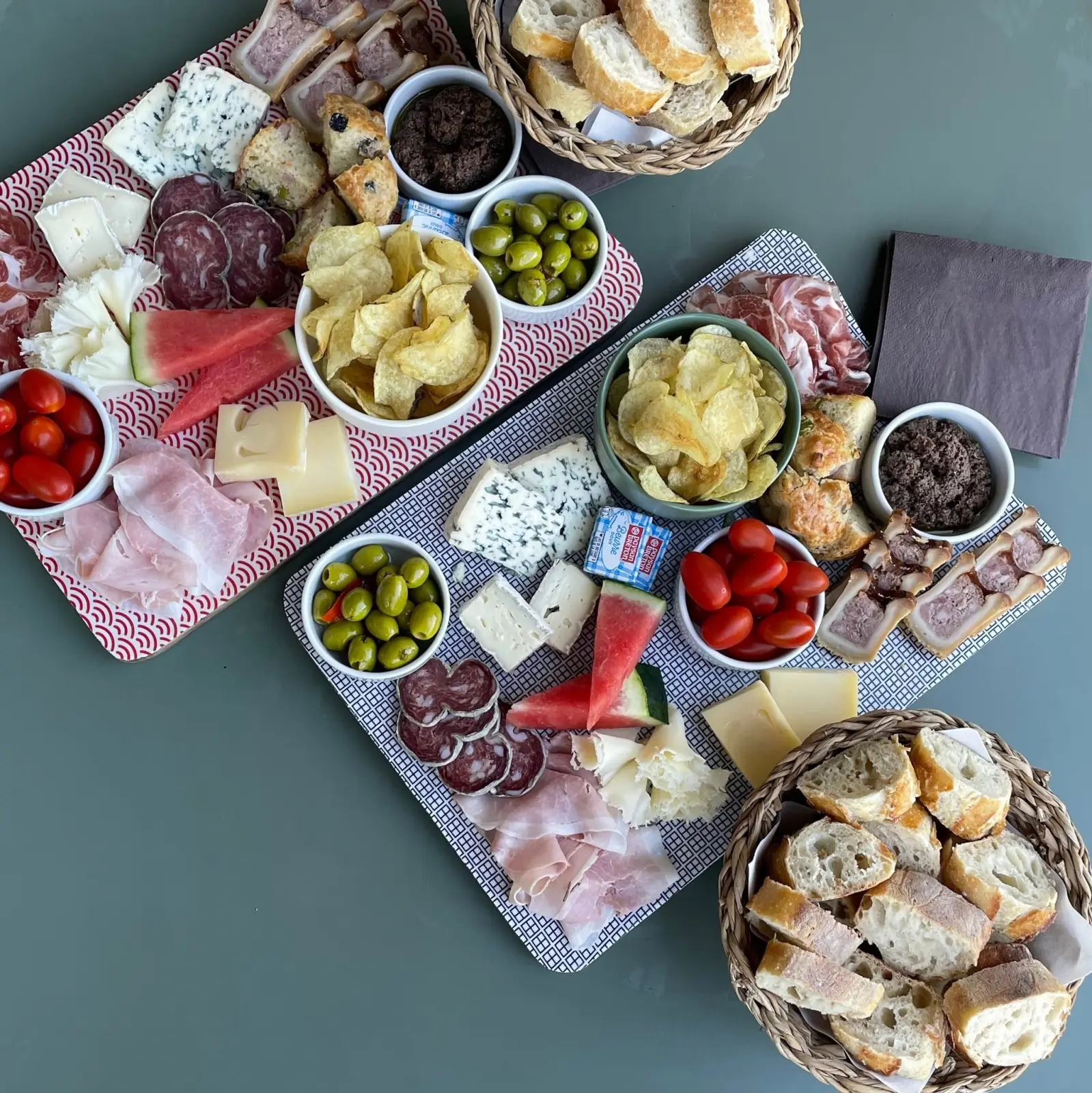 Platters of cured meats, cheese, olives, crisps, watermelon and bread baskets, La Maison des Monts d'Or