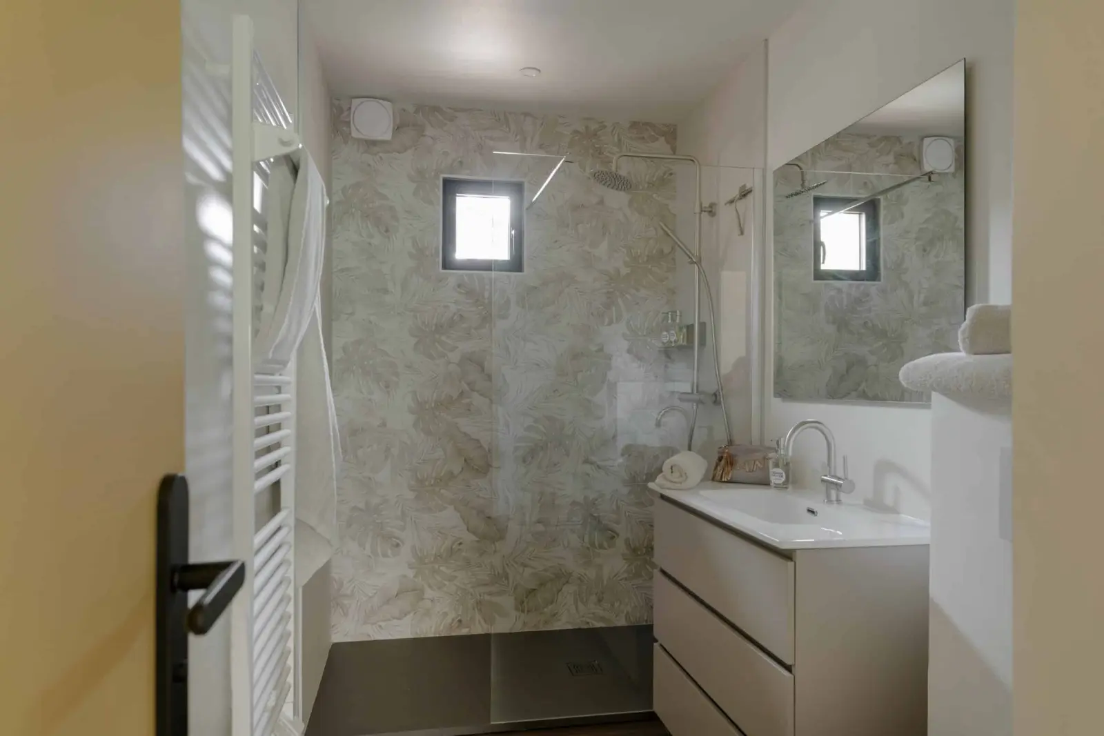 Shower room in the gîte at La Maison des Monts d'Or: walk-in shower, basin and towel rail