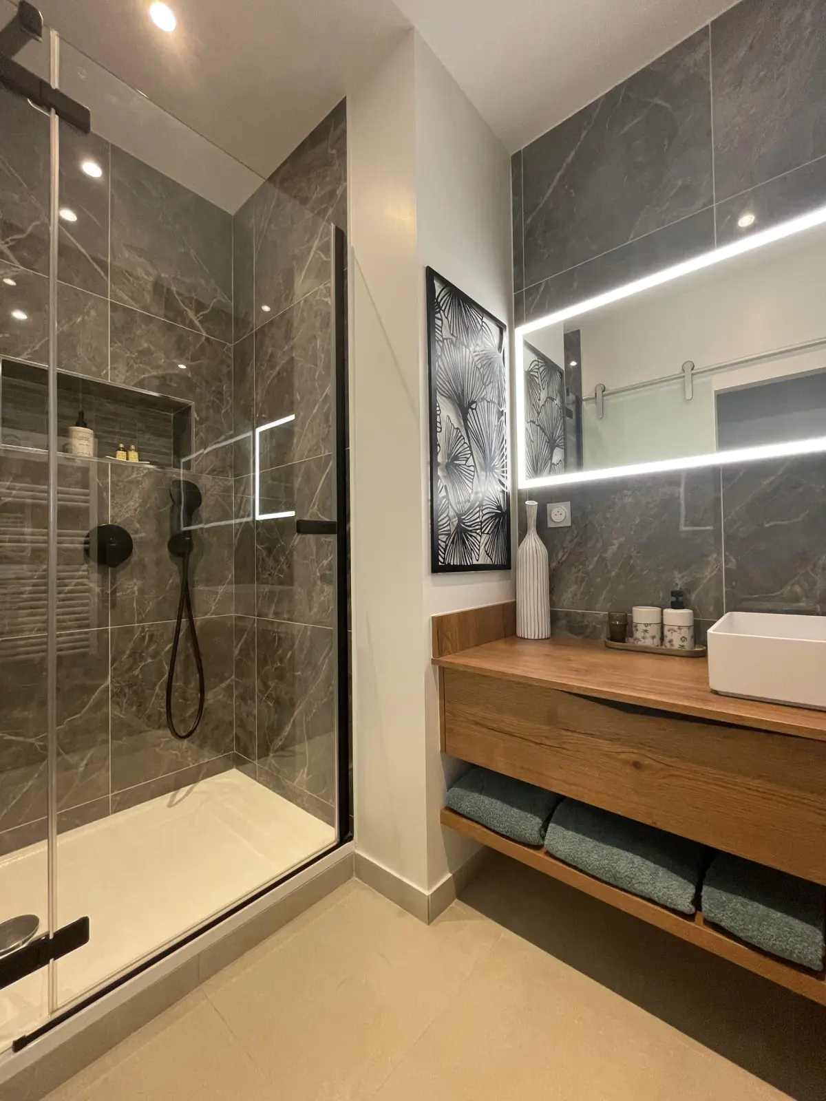 Shower room of the Deauville room at Marculfo, glass shower, grey marble-effect tiles and basin on wood