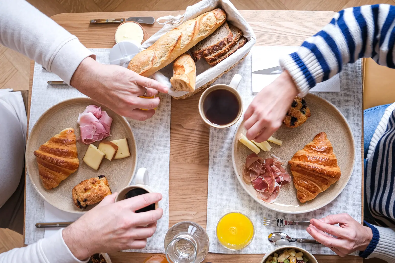 Breakfast for two seen from above: croissants, baguette, ham, cheese, coffee and orange juice, Les Séraphines