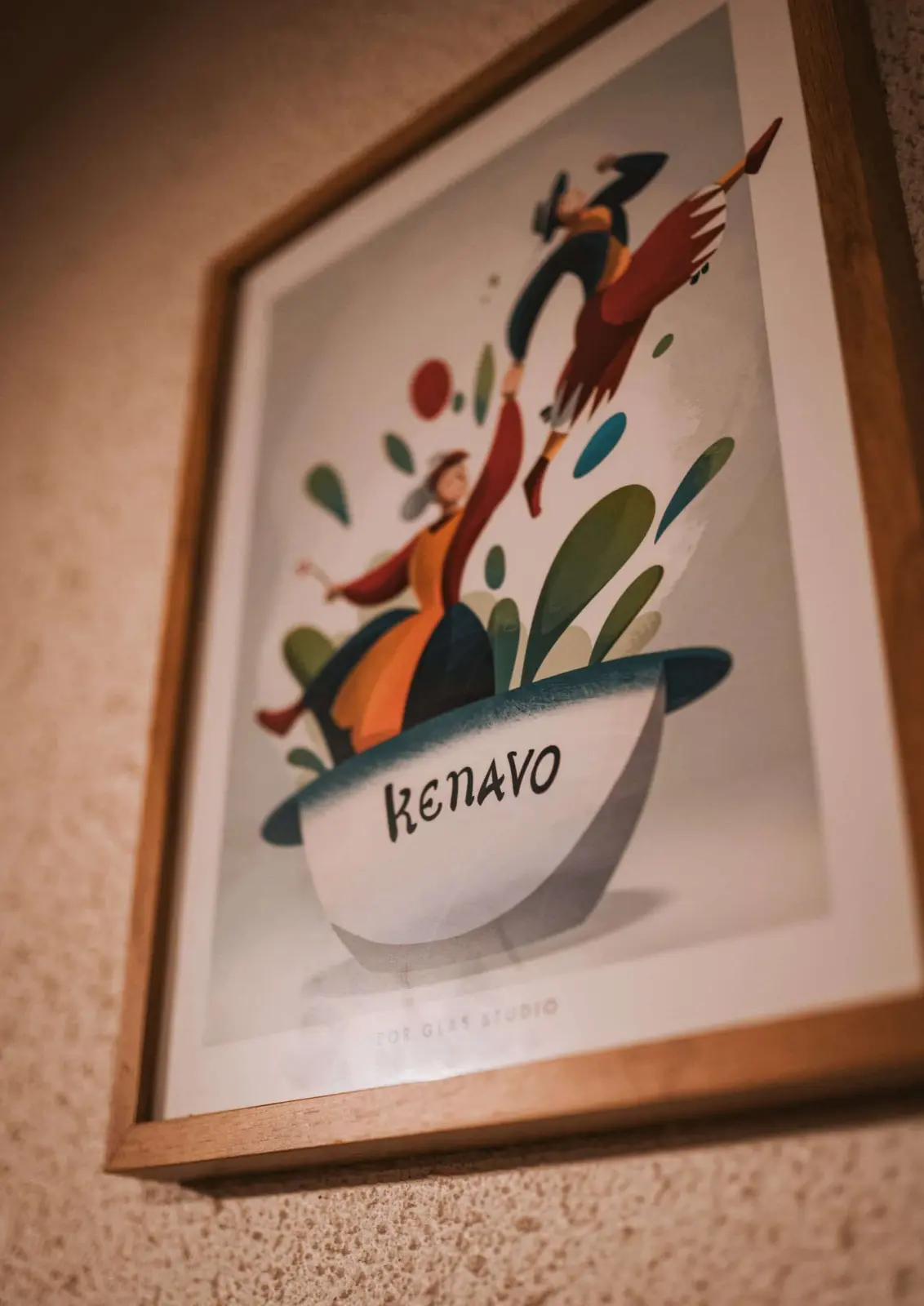Framed “Kenavo” poster with two dancers in traditional costume on a roughcast wall, Ty Monde