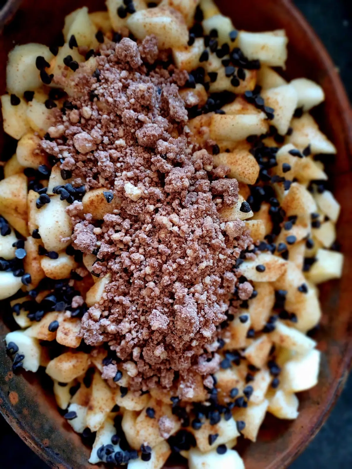 Dish of chopped apples topped with crumble and chocolate chips, at breakfast at Ty Monde
